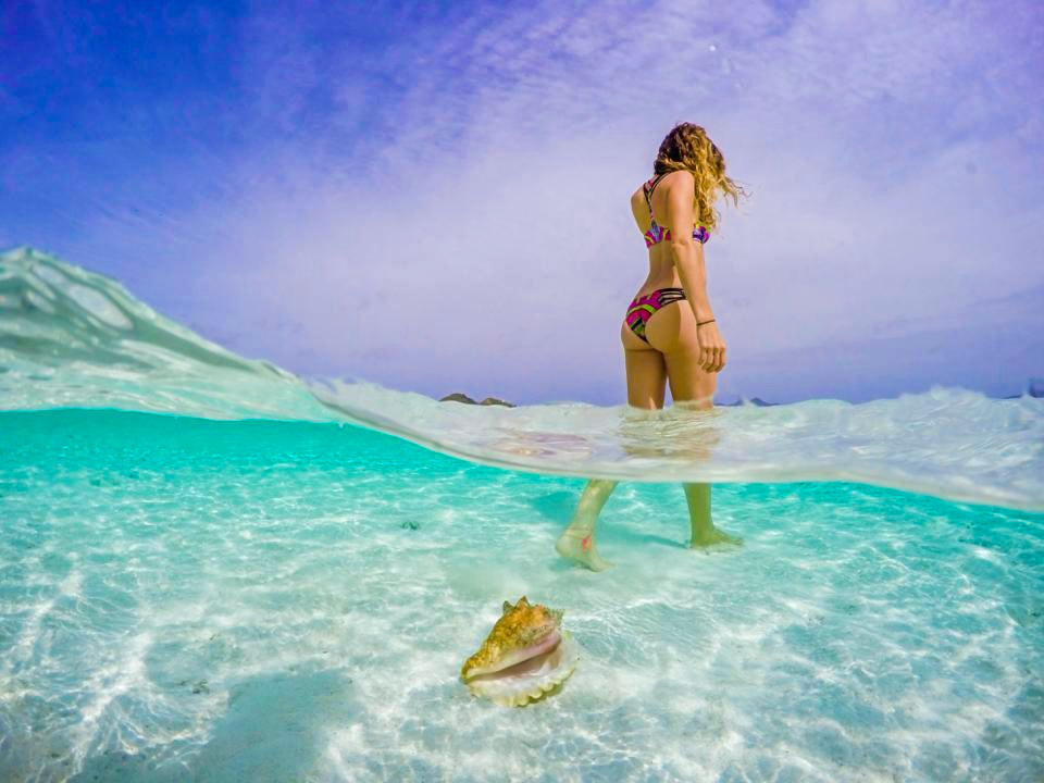 Girl over under water conch